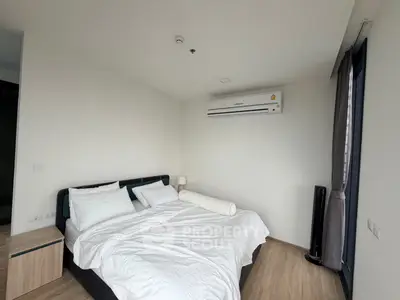 Modern bedroom with air conditioning and minimalist decor in a stylish apartment.