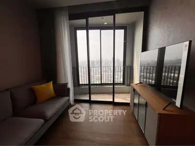 Modern living room with city view, featuring sleek furniture and large windows for natural light.
