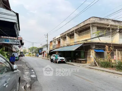 Charming street view of vintage commercial buildings with potential for renovation in a bustling neighborhood.
