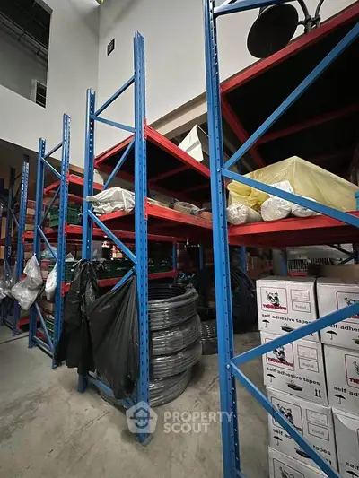 Spacious storage area with industrial shelving and organized supplies, ideal for efficient warehouse operations.