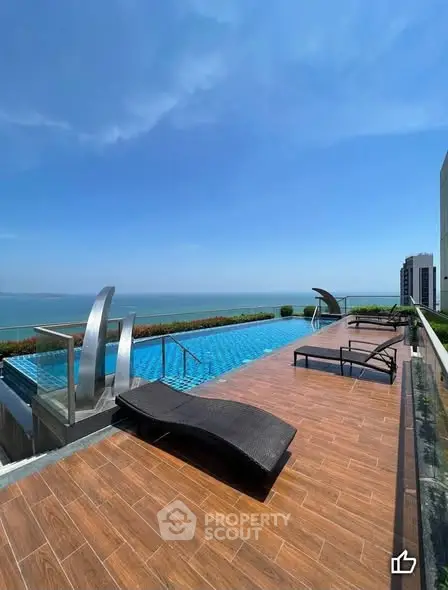 Luxurious rooftop pool with stunning ocean view and modern lounge chairs.