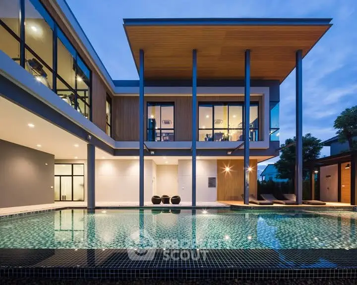 Luxurious modern home with stunning pool and elegant architecture at dusk.