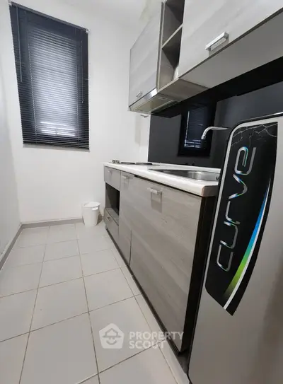 Modern compact kitchen with sleek cabinets and stainless steel appliances