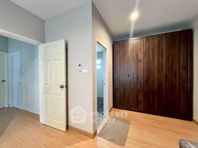 Spacious bedroom with wooden wardrobe and modern design