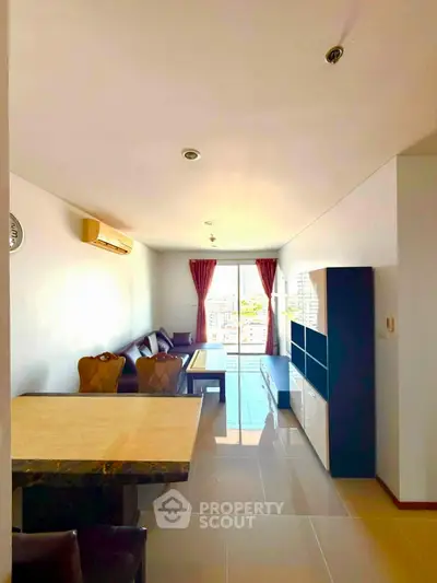 Spacious living room with modern furniture and large windows offering natural light.