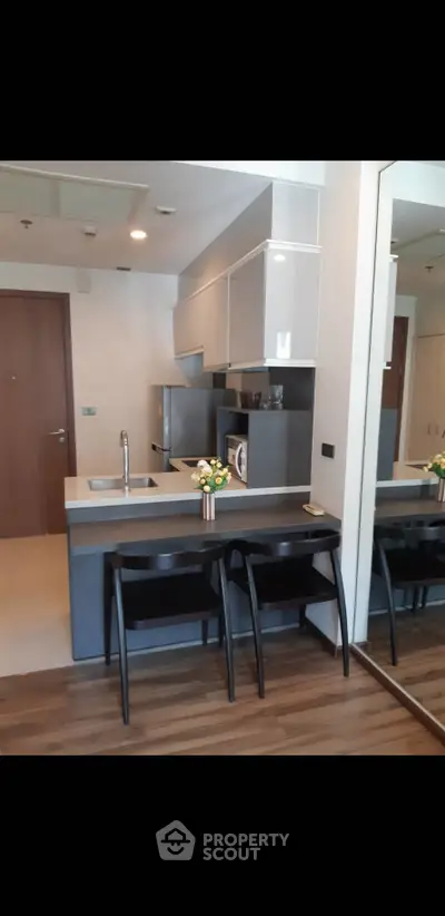 Modern kitchen with sleek design and breakfast bar in stylish apartment