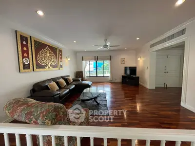 Spacious living room with elegant wooden flooring and stylish decor