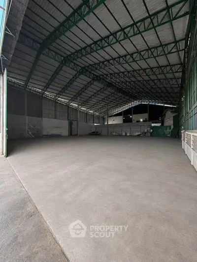 Spacious industrial warehouse with high ceilings and ample storage space.