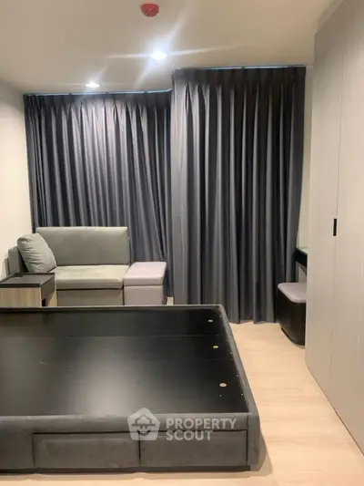 Modern living room with sleek furniture and dark curtains, perfect for cozy evenings.