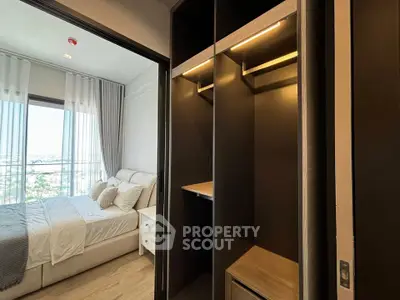 Modern bedroom with walk-in closet and large window offering a stunning view.
