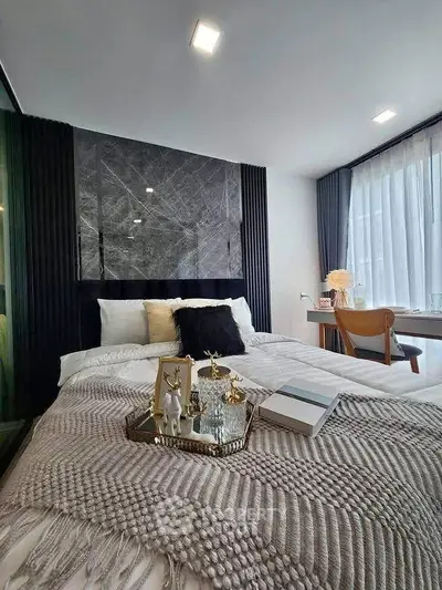 Luxurious bedroom with elegant decor and large window for natural light