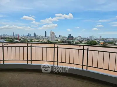 Stunning cityscape view from a high-rise balcony overlooking a river, perfect for urban living enthusiasts.