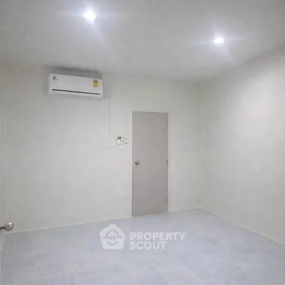 Minimalist unfurnished room with air conditioning and tiled floor, perfect for customization.