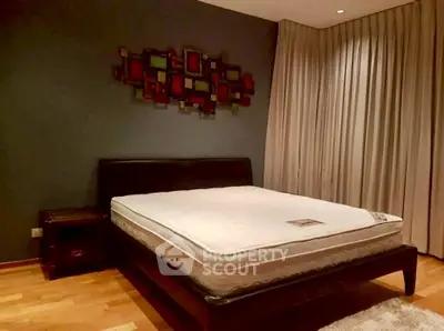 Spacious bedroom with modern decor and large bed, perfect for relaxation.