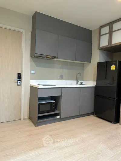 Modern kitchen with sleek cabinets and appliances in a stylish apartment