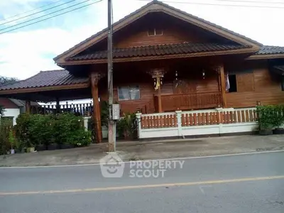Charming traditional wooden house with lush greenery and inviting porch