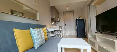 Modern living room with stylish decor and compact kitchen area