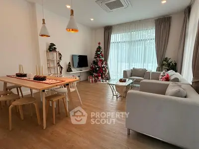 Spacious living room with festive decor and modern furnishings, perfect for holiday gatherings.