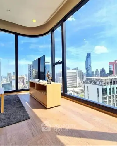 Stunning high-rise living room with panoramic city views and modern decor.