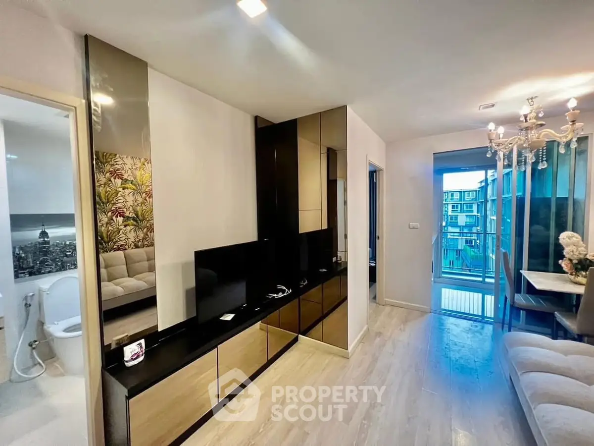 Modern living room with elegant decor and balcony view in a stylish apartment.