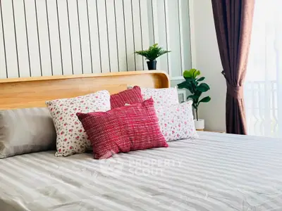 Cozy bedroom with stylish decor and natural light, featuring a comfortable bed and elegant curtains.
