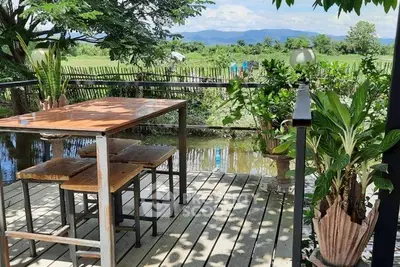 Charming outdoor deck with scenic countryside view, perfect for relaxation and dining.