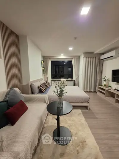 Modern studio apartment with cozy living area and stylish decor