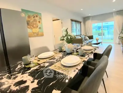 Elegant dining area with marble table and modern decor in a spacious living room.
