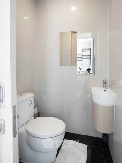 Modern minimalist bathroom with sleek fixtures and compact design