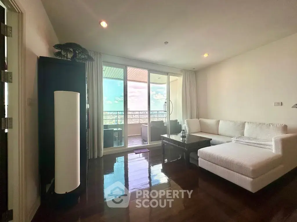 Spacious living room with elegant decor and stunning balcony view