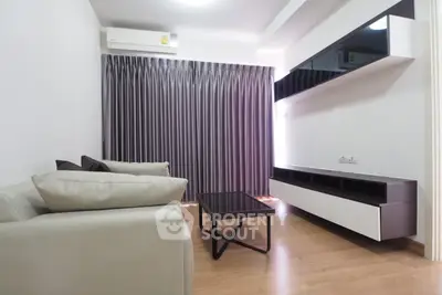 Modern living room with sleek furniture and elegant curtains, perfect for cozy gatherings.