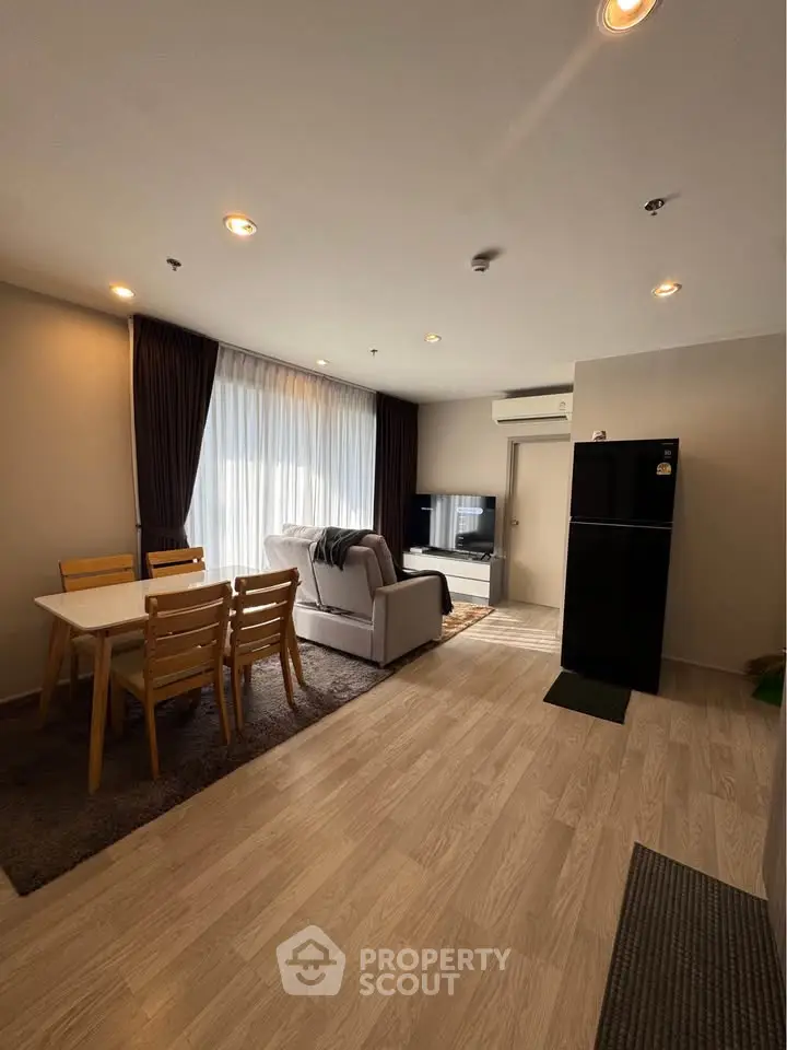 Spacious modern living room with dining area and sleek kitchen appliances