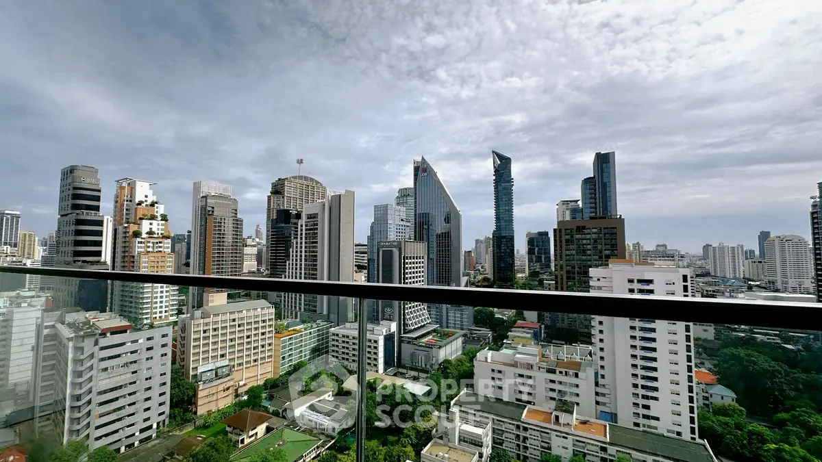 Stunning cityscape view from high-rise balcony showcasing modern skyscrapers and urban skyline.