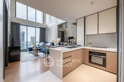 Luxurious open-plan living room with modern kitchen and stunning city view