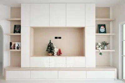 Modern living room with minimalist built-in shelving and holiday decor