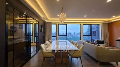 Luxurious open-plan living and dining area with stunning city views and elegant lighting.