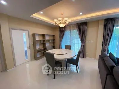 Elegant dining area with marble table and modern chandelier in a spacious living room