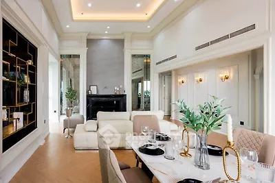 Luxurious living room with elegant dining area, high ceilings, and modern decor