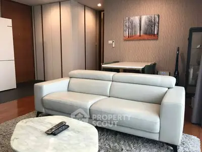 Modern living room with sleek white sofa and stylish decor in a contemporary apartment.