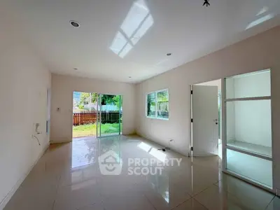 Spacious living room with large windows and garden view