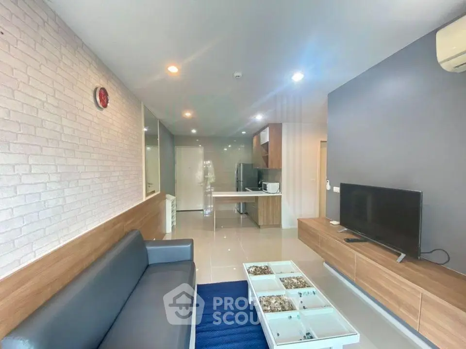 Modern living room with sleek furniture and open kitchen layout, perfect for contemporary living.