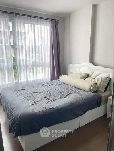 Cozy bedroom with large windows and stylish bed in modern apartment