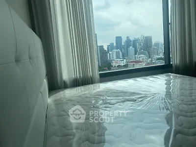 Modern bedroom with city skyline view through large window