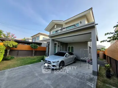 Modern two-story house with carport and landscaped garden