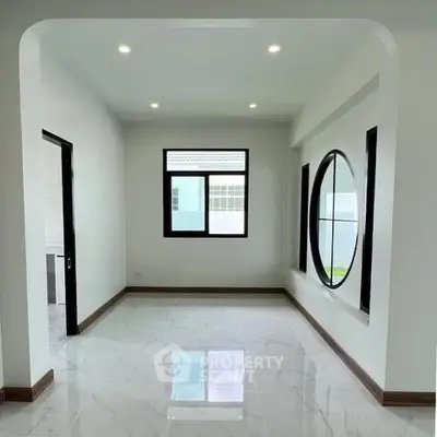 Spacious modern room with large windows and elegant marble flooring