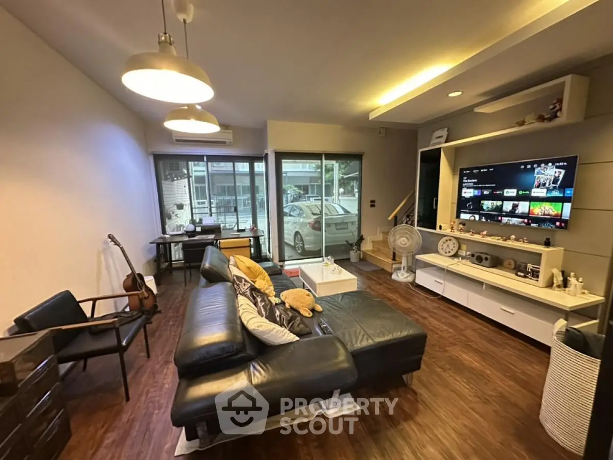 Modern living room with sleek design and large window view