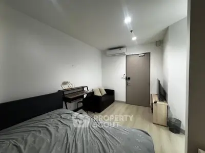 Cozy bedroom with modern furnishings and air conditioning in a stylish apartment.