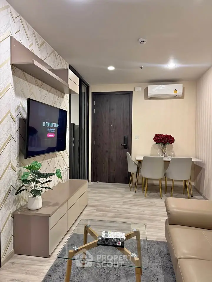 Modern living room with stylish decor and wall-mounted TV, perfect for relaxation.