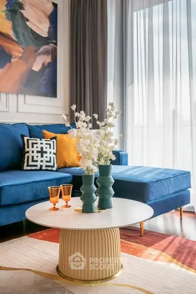 Stylish living room with blue sofa and elegant decor