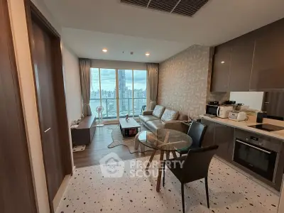 Modern living room with city view, featuring stylish furniture and open kitchen layout.
